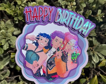 May include: A layered birthday cake topper with the words "HAPPY BIRTHDAY" in red and holographic lettering. The topper features an illustration of three people making peace signs. The background is a light purple and blue.
