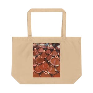 May include: A beige tote bag with a print of numerous red-brown tagines, traditional Moroccan cooking pots. The tagines have conical lids and circular bases. The image is centered on the tote bag.