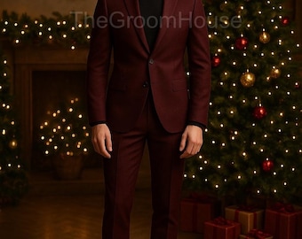 May include: A burgundy suit with a black turtleneck. The suit includes a two-button blazer and matching trousers. The background features Christmas trees, decorative lights, and wrapped gifts. The text "TheGroomHouse" is visible.