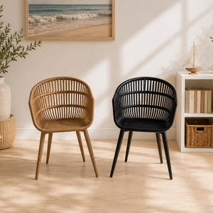May include: Two armchairs with a rounded backrest featuring vertical slats and four tapered legs. One chair is finished in a natural light brown tone, while the other is finished in a solid black color. Both chairs have a curved seat design.