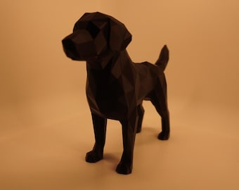 May include: A black geometric Labrador dog sculpture. The dog is standing with its tail up and its head turned slightly to the left. The sculpture is made of many flat, angled surfaces, giving it a faceted appearance. The background is a solid, warm beige color.