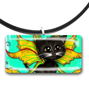 May include: A black cat pendant with yellow and red wings, set against a turquoise background. The pendant is rectangular and hangs from a black cord necklace. The cat has large, expressive eyes.