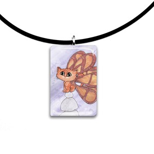 May include: A rectangular pendant necklace featuring an orange kitten with butterfly wings, perched atop a stack of white stones. The pendant hangs from a black cord. The background is a soft, watercolor-style purple.