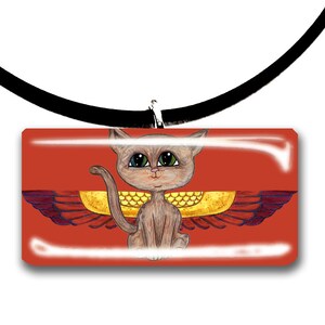 May include: A rectangular pendant necklace featuring a cartoon cat with large eyes and golden wings, set against a red background. The cat is light brown, and the wings have red and gold details. The pendant is attached to a black cord.