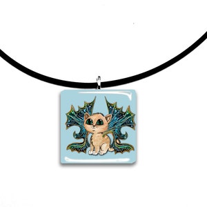 May include: A square pendant necklace featuring a cartoon kitten with teal and gold fairy wings. The kitten has large green eyes and is set against a light blue background. The pendant hangs from a black cord.