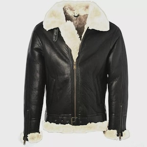 May include: Black leather jacket with a cream-colored shearling collar and lining. The jacket features a zip-up front, a buckled belt at the waist, and zippered cuffs. A classic, warm outerwear piece.