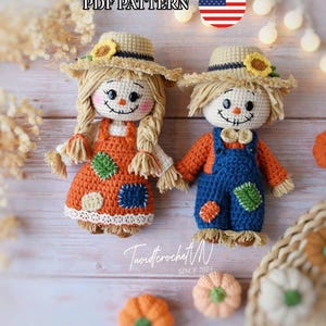 May include: Two crochet scarecrow dolls featuring straw-like hair, tan hats with sunflowers, and stitched facial features. The left doll wears an orange dress with patches, while the right doll wears blue overalls over an orange shirt. Text reads PDF PATTERN.