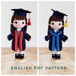 May include: Two crochet dolls in graduation outfits, each with a dark blue cap and gown. One doll has red trim, the other has blue trim. The dolls have brown hair and stand on a wooden surface. The text "ENGLISH PDF PATTERN" is at the bottom.