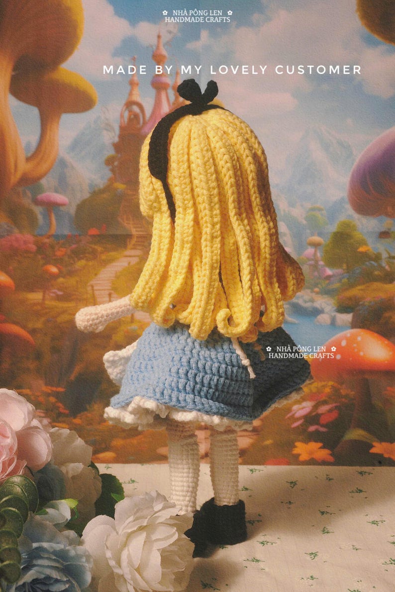 May include: A handmade crochet doll of a character with yellow hair, a blue dress, and black shoes. The doll is positioned in front of a whimsical background. The text "MADE BY MY LOVELY CUSTOMER" is visible.