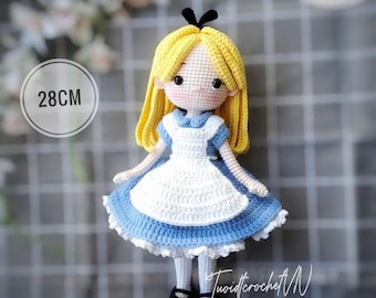 May include: A handmade crochet doll, 28cm tall, resembling Alice from Alice in Wonderland. The doll has yellow hair, a blue and white dress, and black shoes. The image includes the text "ENGLISH PDF PATTERN" and the artist's signature.