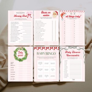 May include: A collection of six baby shower game cards with pink and white backgrounds. The games include "Who Knows Mommy Best," "Over or Under," "A-Z all things baby!," "Baby Guesses," "Baby Bingo," and "Baby Shower Unscramble."