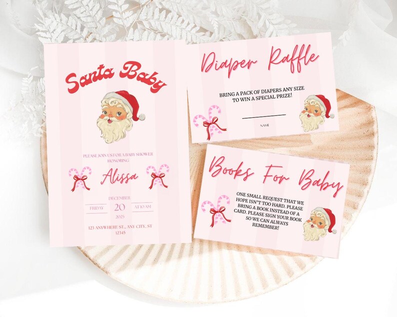 May include: Pink baby shower invitations with a Santa theme. The invitation includes the text "Santa Baby" and "Diaper Raffle". The design features a Santa Claus illustration and candy cane accents. The invitation is on a light pink background.