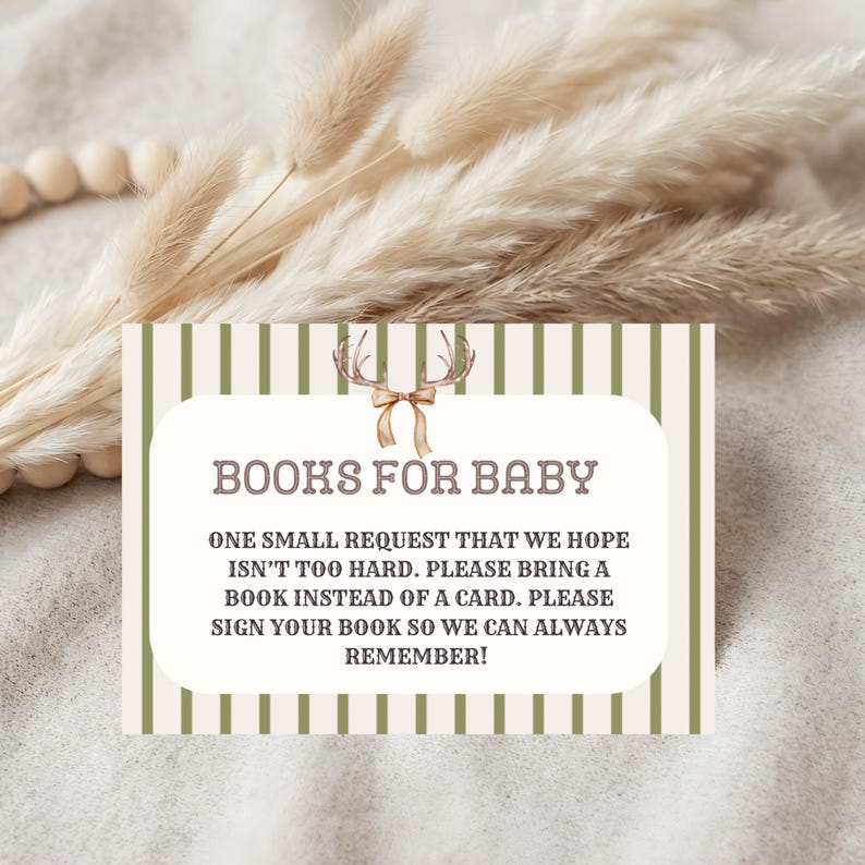 May include: A rectangular card with a white center and olive green vertical stripes. The text reads: BOOKS FOR BABY. ONE SMALL REQUEST THAT WE HOPE ISN'T TOO HARD. PLEASE BRING A BOOK INSTEAD OF A CARD. PLEASE SIGN YOUR BOOK SO WE CAN ALWAYS REMEMBER!