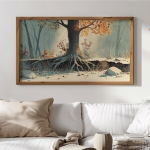 May include: A framed watercolor painting of a tree with exposed roots in a forest setting. The tree has orange and yellow leaves, and the painting is set in a wooden frame. The artwork is displayed above a white couch.