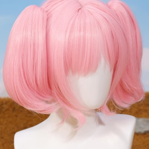 Beautiful pastel pink Madoka Kaname wig displayed on a mannequin head, highlighting the smooth, heat-resistant synthetic fibers and pre-styled twin tails. This cosplay wig accurately replicates the character’s hairstyle from Puella Magi Madoka Magica and comes with breathable rose net cap for comfort. Suitable for cosplayers, anime collectors, and fans seeking authentic cosplay accessories or thoughtful gifts for gamers and anime lovers.