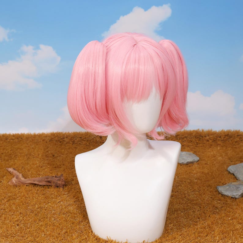 Back view of the Madoka Kaname pink twin tail wig showing the adjustable straps and rose net cap construction for a secure fit. The wig is crafted from high-temperature resistant matte synthetic fibers, allowing safe styling. Perfect for Puella Magi Madoka Magica fans, platform gamers, and cosplayers looking for a quality accessory for anime conventions, photoshoots, and birthday gifts.