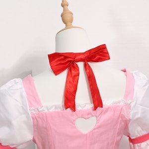 Side angle of the Madoka Kaname cosplay costume emphasizing the puffed sleeves, layered skirt, and tailored fit. The use of white wedding satin and red satin makes the costume stand out under stage or event lighting. This full set is perfect for anime gamer girls or anyone searching for a cosplay party outfit that blends style with authenticity. A thoughtful gift for cosplay fans, especially during holidays or birthdays.