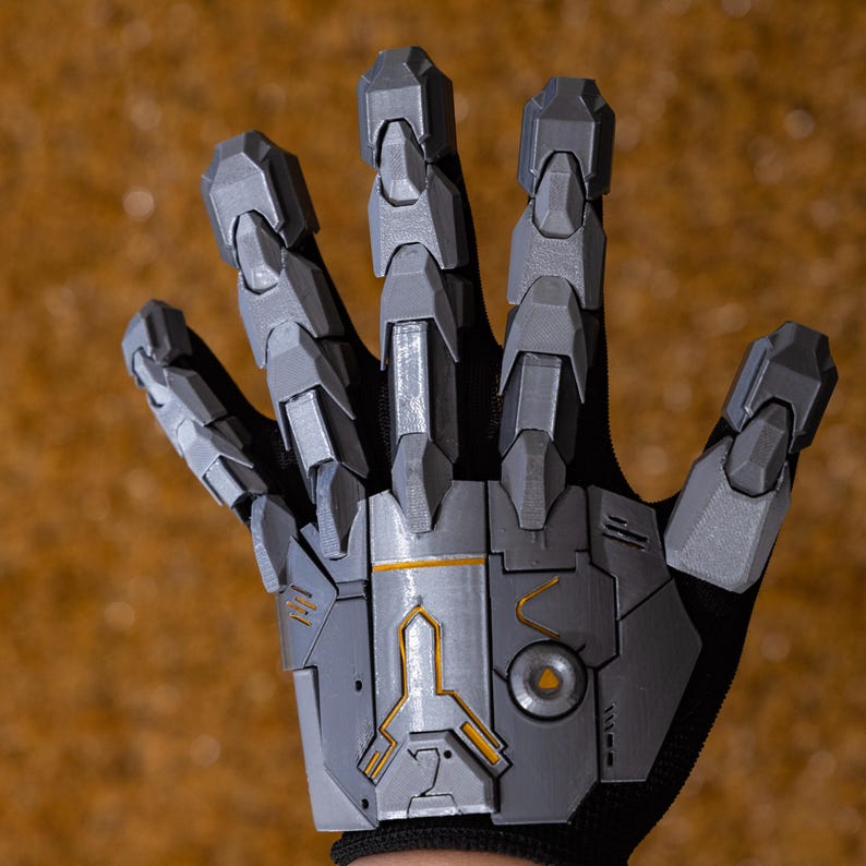 Cyberpunk Mecha Gloves displayed in a close-up angle that captures the fine mechanical details, layered plating, and precisely engineered joints of the 3D printed exoskeleton armor. The gloves are positioned on a textured background to emphasize their high-end craftsmanship and durable PLA construction. This image illustrates how the gloves elevate any sci-fi costume or futuristic streetwear outfit, appealing to gamers