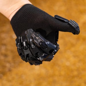 Cyberpunk Mecha Gloves arranged in a flat lay composition with all three color options—black, silver, and white/orange—neatly displayed side by side, highlighting the versatility and customization available to suit different cosplay themes or techwear styles. Each glove features the same detailed 3D printed armor shell, intricate mechanical paneling, and soft inner liner for comfort and stability