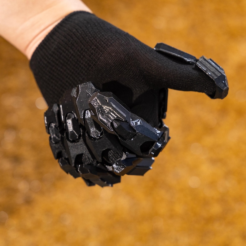Cyberpunk Mecha Gloves arranged in a flat lay composition with all three color options—black, silver, and white/orange—neatly displayed side by side, highlighting the versatility and customization available to suit different cosplay themes or techwear styles. Each glove features the same detailed 3D printed armor shell, intricate mechanical paneling, and soft inner liner for comfort and stability
