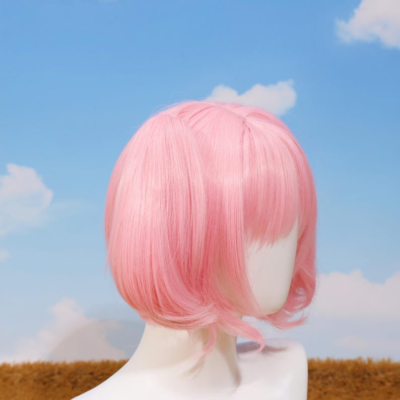 Madoka Kaname cosplay wig styled with soft pastel pink twin tails and parted bangs, designed for anime fans who love Puella Magi Madoka Magica. This high-quality synthetic wig features heat-resistant fibers, making it perfect for conventions, cosplay photoshoots, platform game player gifts, and birthday presents. The detachable twin tails attach easily with secure tiger-mouth clips, allowing flexible styling. Ideal for magical girl transformations and anime costume collections.