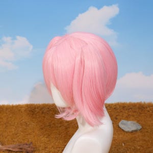 Side angle of Madoka Kaname cosplay wig with pink twin tails attached using secure tiger-mouth clips. The breathable rose net cap ensures comfort during long wear at conventions or photoshoots. This synthetic heat-resistant wig is a perfect choice for platform game player gifts, cosplay birthday surprises, and anime holiday celebrations. Ideal for transforming into your favorite magical girl character with ease.