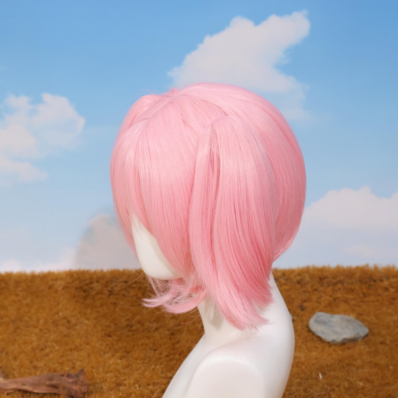 Side angle of Madoka Kaname cosplay wig with pink twin tails attached using secure tiger-mouth clips. The breathable rose net cap ensures comfort during long wear at conventions or photoshoots. This synthetic heat-resistant wig is a perfect choice for platform game player gifts, cosplay birthday surprises, and anime holiday celebrations. Ideal for transforming into your favorite magical girl character with ease.