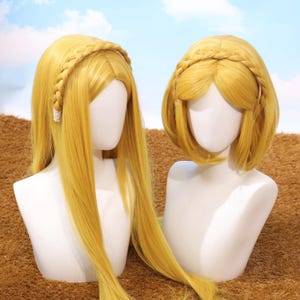 May include: Two blonde wigs displayed on white mannequin heads. One wig has long, straight hair, the other a shorter bob. Both have a braided headband. The background shows a blue sky and a brown surface.