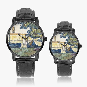 May include: Two black wristwatches with leather straps. The watch faces display a colorful landscape scene with boats, a building, and trees. The watches have black bezels and hands.