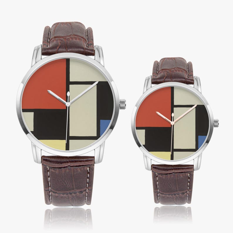 May include: Two wristwatches with silver cases and brown leather straps. The watch faces feature a geometric design with red, black, white, yellow, and blue blocks. The watches are displayed on a white background.