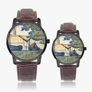 May include: Two wristwatches with black cases and brown leather straps. The watch faces display a colorful landscape scene with boats, a building, and trees. The watch hands are black, and the straps have a textured finish.