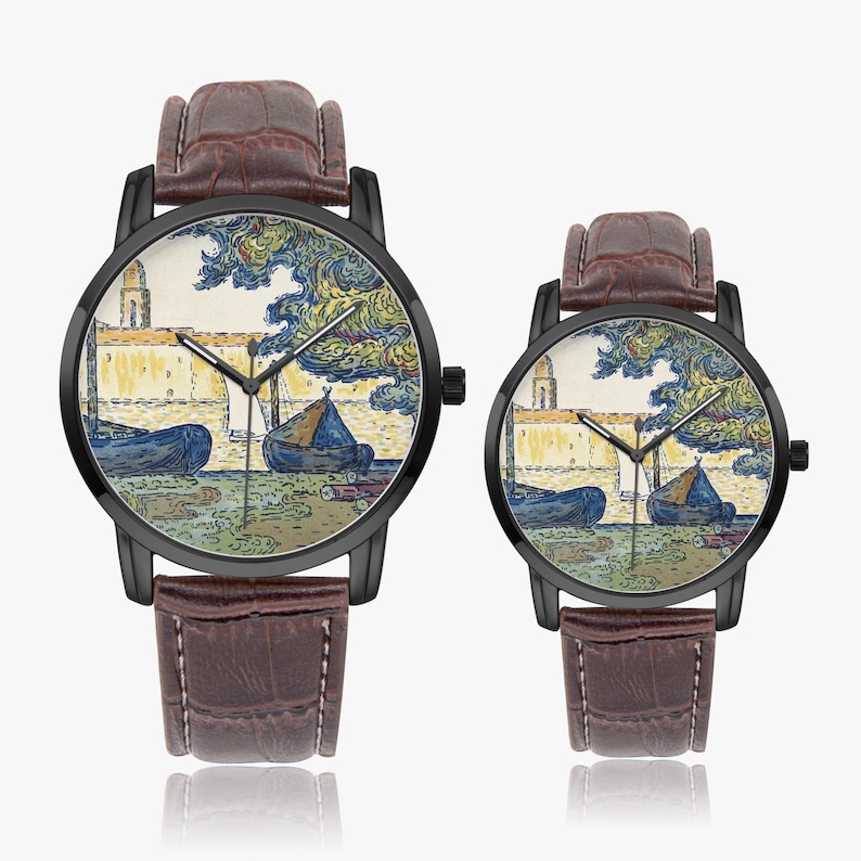 May include: Two wristwatches with black cases and brown leather straps. The watch faces display a colorful landscape scene with boats, a building, and trees. The watch hands are black, and the straps have a textured finish.