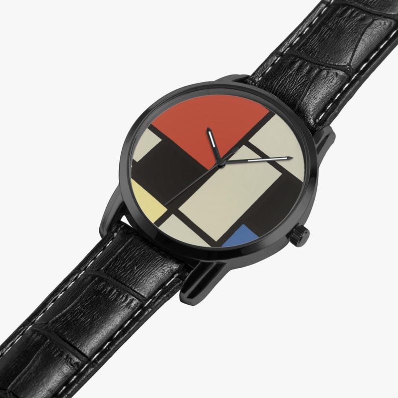 May include: Black wristwatch with a geometric design on the face, featuring red, black, yellow, and blue shapes. The watch has a black leather band with white stitching. The watch face has a diameter of approximately 1.5 inches.