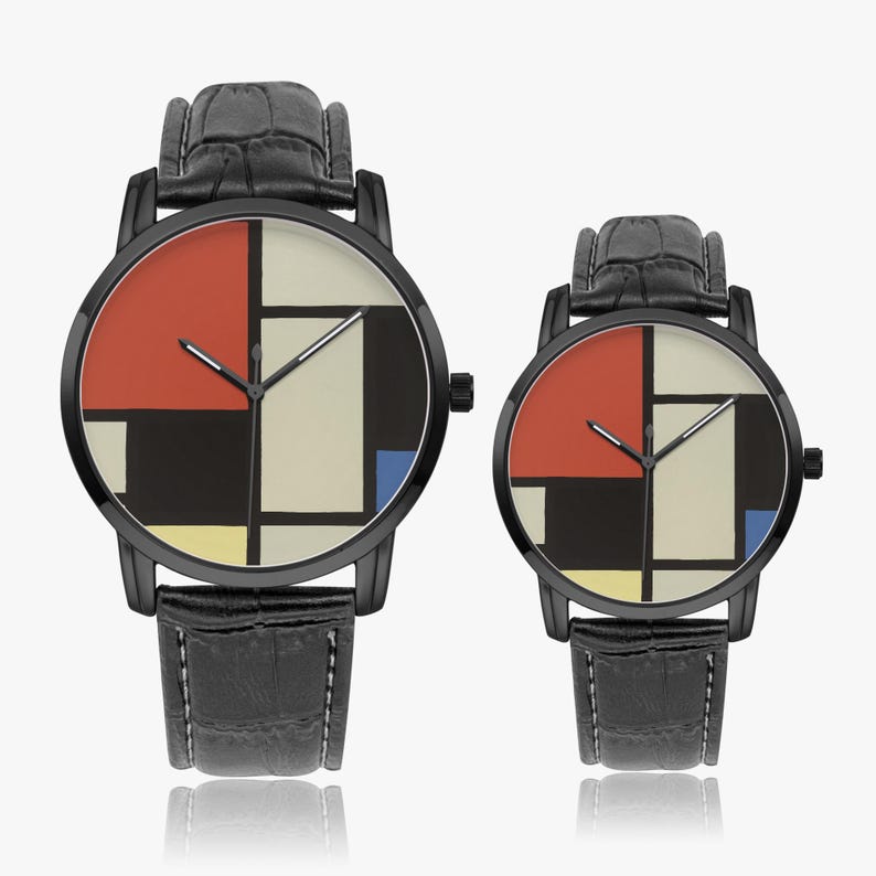 May include: Two black wristwatches with leather straps. The watch faces feature a geometric design with red, black, white, and blue blocks. The watches are displayed on a white surface.