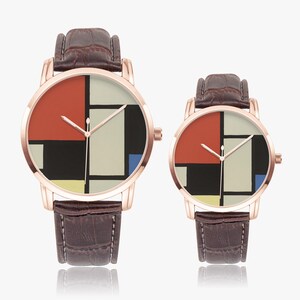 May include: Two rose gold watches with brown leather straps. The watch faces feature a geometric design with red, black, white, yellow, and blue blocks. The watches are displayed on a white background.