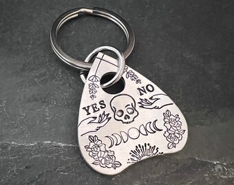 Hand stamped Ouija planchette keychain.