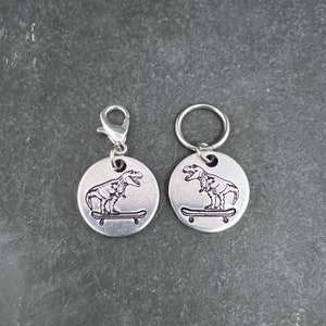 Hand stamped t-Rex on a skateboard stitch marker