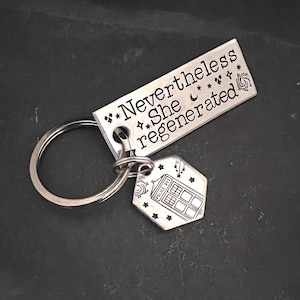 Hand stamped &quot;Nevertheless she regenerated&quot; Doctor Who inspired keychain with tardis charm.