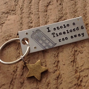 Hand stamped &quot;I stole a Timelord & ran away&quot; Doctor Who inspired keychain with star charm.