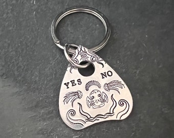 Hand stamped Ouija Cthulhu planchette keychain.