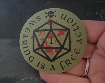 May include: A green round sticker with a black skull and crossbones at the top. The sticker says "Your action is a free earning" and has a black and white image of a blood-splattered dice with a red "1" in the center.