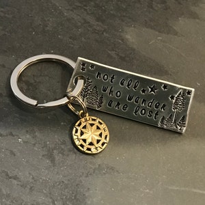 Hand stamped &quot;Not all who wander are lost” keychain with compass charm