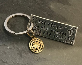 Hand stamped "Not all who wander are lost” keychain with compass charm