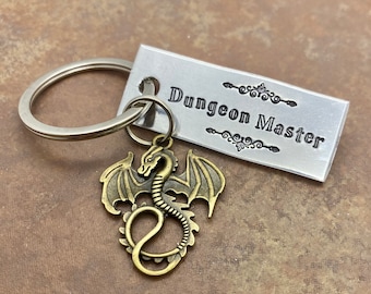 DND inspired “Dungeon Master” hand stamped keychain with a choice of D20 stamped charm or a dragon charm