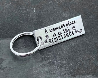 Hand stamped "A woman’s place is in the resistance" keychain.
