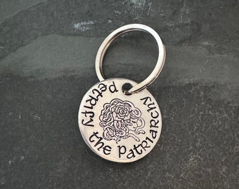 Hand stamped "Petrify the patriarchy” keychain.