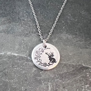 Micro jackalope under a flowered crescent moon hand stamped necklace