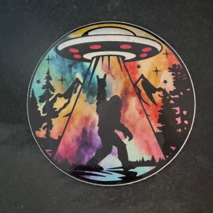 Holographic Bigfoot abduction sunset sticker