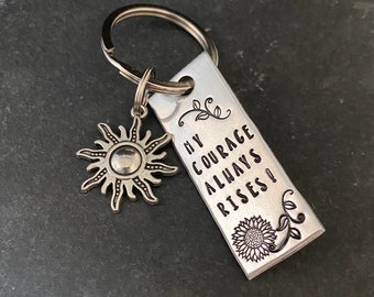 Hand stamped "My courage always rises”  keychain with a choice of accompanying charm