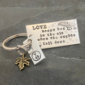 Hand stamped "LOVE keeps her in the air..." Firefly inspired keychain with hand stamped charm